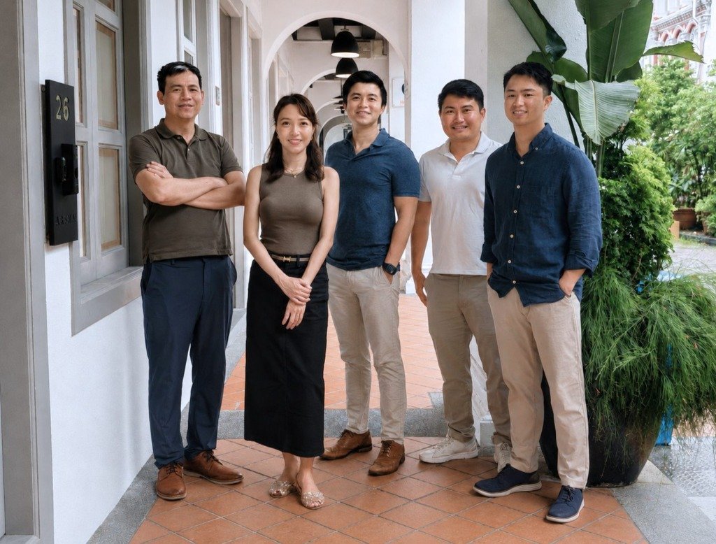 The Timah Partners team standing together outside their Singapore office